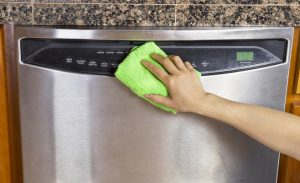 Wiping Clean Dishwasher with Microfiber rag